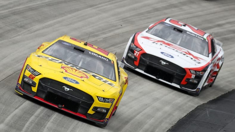 May 1, 2023; Dover, Delaware, USA; NASCAR Cup Series driver Joey Logano (22) races driver Harrison Burton (21) during the Wurth 400 at Dover Motor Speedway. Mandatory Credit: Matthew OHaren-USA TODAY Sports