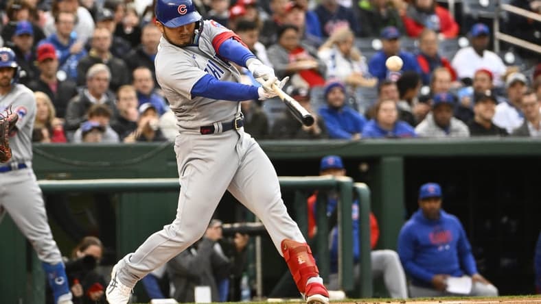 May 1, 2023; Washington, District of Columbia, USA; Chicago Cubs right fielder Seiya Suzuki (27) hits an RBI single against the Washington Nationals during the first inning at Nationals Park. Mandatory Credit: Brad Mills-USA TODAY Sports
