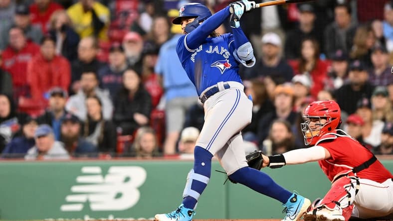 May 1, 2023; Boston, Massachusetts, USA; Toronto Blue Jays shortstop Bo Bichette (11) hits a three-run home run against the Boston Red Sox during the second inning at Fenway Park. Mandatory Credit: Brian Fluharty-USA TODAY Sports