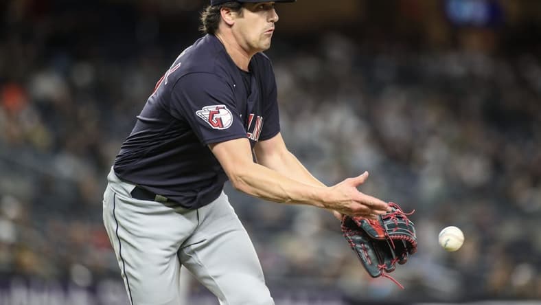 May 1, 2023; Bronx, New York, USA; Cleveland Guardians starting pitcher Cal Quantrill (47) makes a flip throw to first base for an assist in the seventh inning against the New York Yankees at Yankee Stadium. Mandatory Credit: Wendell Cruz-USA TODAY Sports