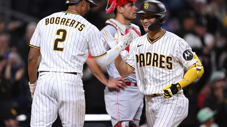 May 1, 2023; San Diego, California, USA; San Diego Padres second baseman Ha-seong Kim (7) is congratulated by shortstop Xander Bogaerts (2) after hitting a three-run home run against the Cincinnati Reds during the fifth inning at Petco Park. Mandatory Credit: Orlando Ramirez-USA TODAY Sports