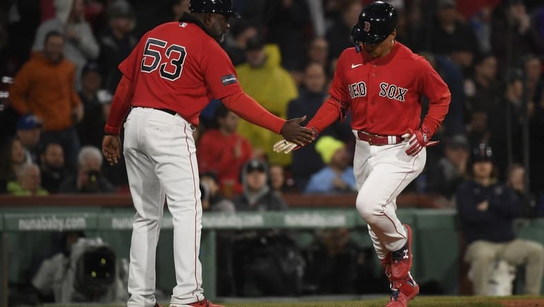 May 2, 2023; Boston, Massachusetts, USA;  Boston Red Sox designated hitter Masataka Yoshida (7) is congratulated by third base coach Carlos Febles (53) after hitting a home run during the fifth inning against the Toronto Blue Jays at Fenway Park. Mandatory Credit: Bob DeChiara-USA TODAY Sports