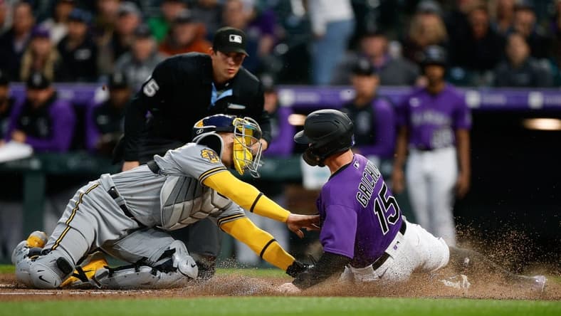 May 2, 2023; Denver, Colorado, USA; Colorado Rockies right fielder Randal Grichuk (15) is tagged out sliding into home against Milwaukee Brewers catcher William Contreras (24) in the fourth inning at Coors Field. Mandatory Credit: Isaiah J. Downing-USA TODAY Sports