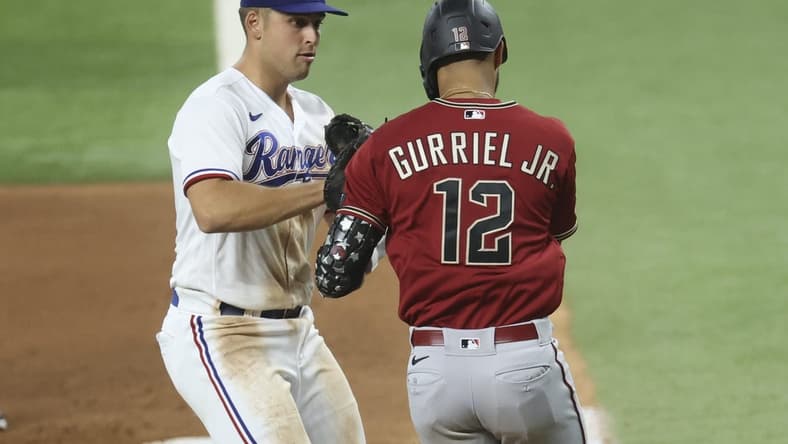 May 2, 2023; Arlington, Texas, USA; Texas Rangers first baseman Nathaniel Lowe (30) tags out Arizona Diamondbacks left fielder Lourdes Gurriel Jr. (12) during the fourth inning at Globe Life Field. Mandatory Credit: Kevin Jairaj-USA TODAY Sports