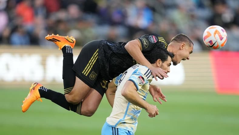 May 2, 2023; Los Angeles, CA, USA; LAFC defender Aaron Long (33) and Philadelphia Union forward Julian Carranza (9) battle for the ball in the first half at BMO Stadium. Mandatory Credit: Kirby Lee-USA TODAY Sports