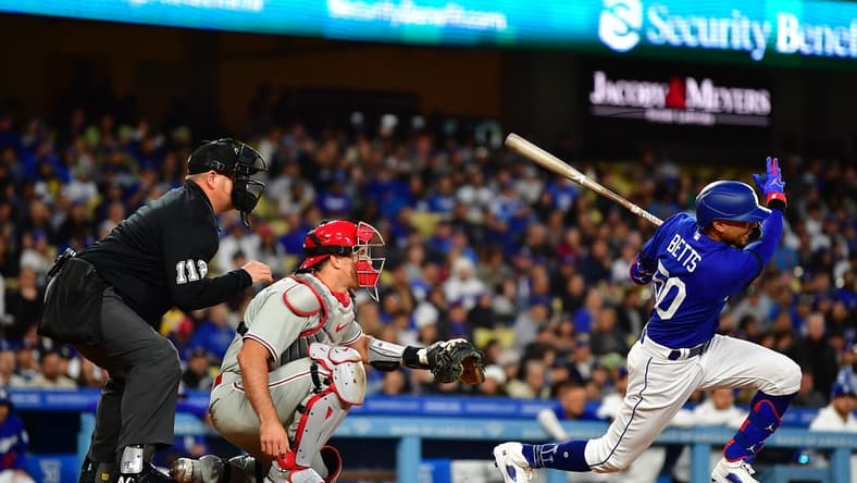 May 2, 2023; Los Angeles, California, USA; Los Angeles Dodgers right fielder Mookie Betts (50) hits a two run RBI single against the Philadelphia Phillies during the second inning at Dodger Stadium. Mandatory Credit: Gary A. Vasquez-USA TODAY Sports