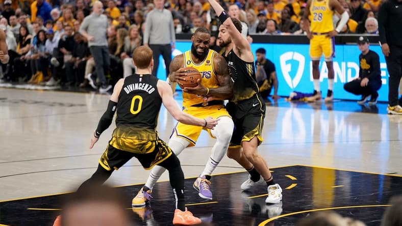 May 2, 2023; San Francisco, California, USA; Los Angeles Lakers forward LeBron James (6) drives to the hoop between Golden State Warriors guard Donte DiVincenzo (0) and guard Klay Thompson (11) in the second quarter during game one of the 2023 NBA playoffs at the Chase Center. Mandatory Credit: Cary Edmondson-USA TODAY Sports
