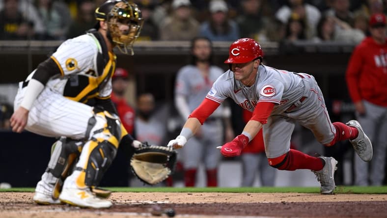 May 2, 2023; San Diego, California, USA; Cincinnati Reds center fielder TJ Friedl (right) scores a run ahead of the throw to San Diego Padres catcher Austin Nola (left) during the eighth inning at Petco Park. Mandatory Credit: Orlando Ramirez-USA TODAY Sports