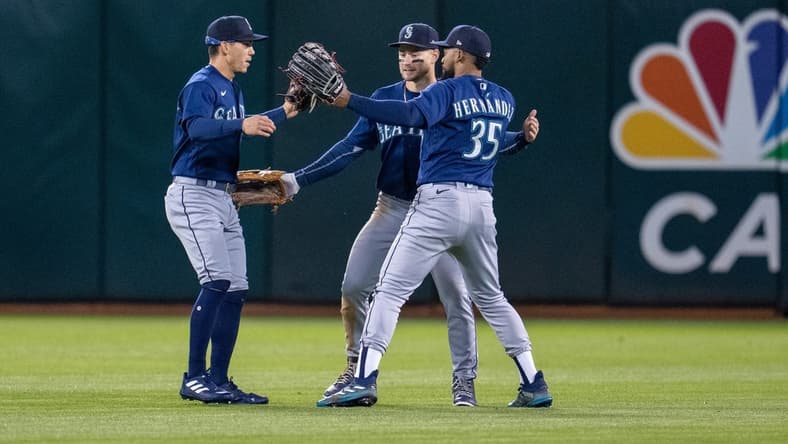 May 2, 2023; Oakland, California, USA;  Seattle Mariners center fielder Jarred Kelenic (10), right fielder Teoscar Hernandez (35) and Seattle Mariners left fielder Sam Haggerty (0) celebrate after defeating the Oakland Athletics at RingCentral Coliseum. Mandatory Credit: Neville E. Guard-USA TODAY Sports