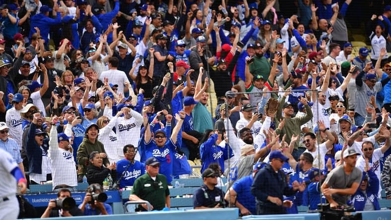 May 3, 2023; Los Angeles, California, USA; Fans cheer after Los Angeles Dodgers third baseman Max Muncy (13) hits a walk off grand slam home run against the Philadelphia Phillies during the ninth inning at Dodger Stadium. Mandatory Credit: Gary A. Vasquez-USA TODAY Sports