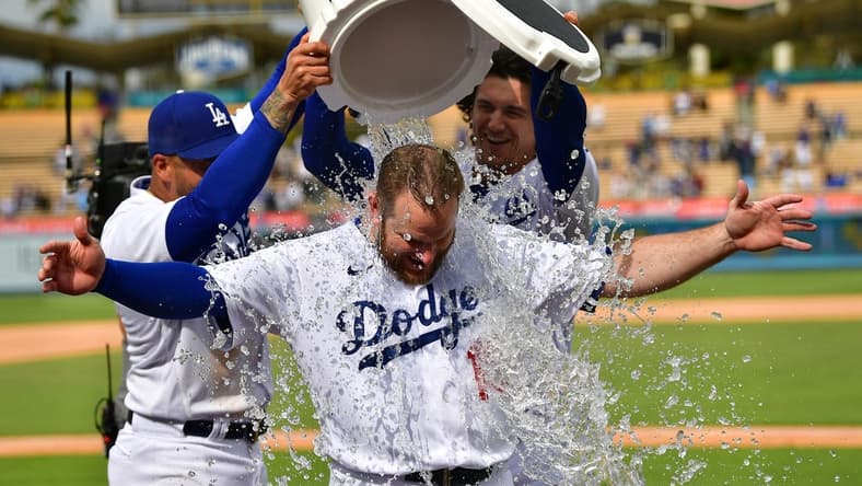 May 3, 2023; Los Angeles, California, USA; Los Angeles Dodgers left fielder David Peralta (6) and center fielder James Outman (33) pour water on third baseman Max Muncy (13) after he his a walk off grand slam home run against the Philadelphia Phillies at Dodger Stadium. Mandatory Credit: Gary A. Vasquez-USA TODAY Sports