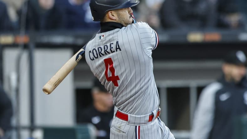 May 3, 2023; Chicago, Illinois, USA; Minnesota Twins shortstop Carlos Correa (4) hits a two-run double against the Chicago White Sox during the third inning at Guaranteed Rate Field. Mandatory Credit: Kamil Krzaczynski-USA TODAY Sports