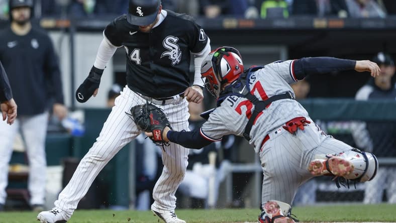 May 3, 2023; Chicago, Illinois, USA; Minnesota Twins catcher Ryan Jeffers (27) tags out Chicago White Sox catcher Yasmani Grandal (24) at home plate during the fourth inning at Guaranteed Rate Field. Mandatory Credit: Kamil Krzaczynski-USA TODAY Sports