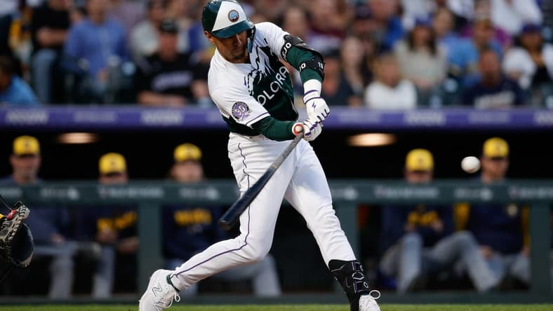 May 3, 2023; Denver, Colorado, USA; Colorado Rockies second baseman Alan Trejo (13) hits a three RBI double in the fourth inning against the Milwaukee Brewers at Coors Field. Mandatory Credit: Isaiah J. Downing-USA TODAY Sports