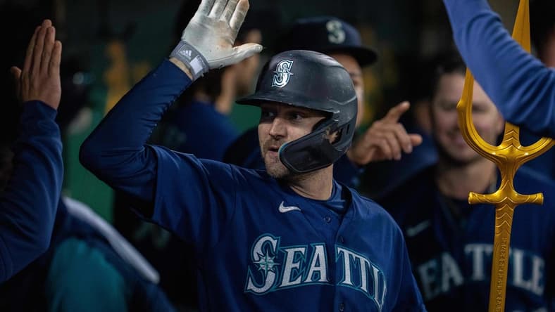 May 3, 2023; Oakland, California, USA; Seattle Mariners left fielder AJ Pollock (8) celebrates in the dugout after hitting a solo home run against the Oakland Athletics during the ninth inning at Oakland-Alameda County Coliseum. Mandatory Credit: Neville E. Guard-USA TODAY Sports