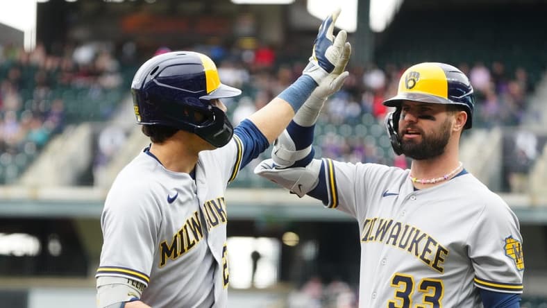 May 4, 2023; Denver, Colorado, USA; Milwaukee Brewers first baseman Rowdy Tellez (11) celebrates his solo home run with designated hitter Jesse Winker (33) run against the Colorado Rockies in the first inning at Coors Field. Mandatory Credit: Ron Chenoy-USA TODAY Sports