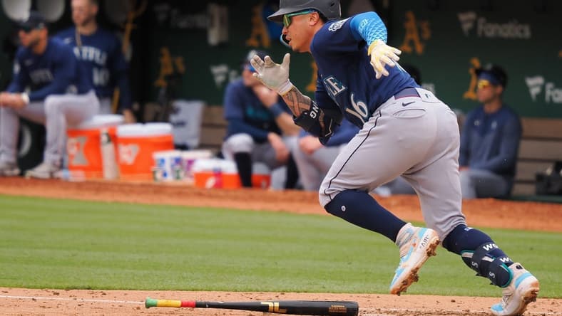 May 4, 2023; Oakland, California, USA; Seattle Mariners second baseman Kolten Wong (16) runs for first base on an RBI single against the Oakland Athletics during the fourth inning at Oakland-Alameda County Coliseum. Mandatory Credit: Kelley L Cox-USA TODAY Sports