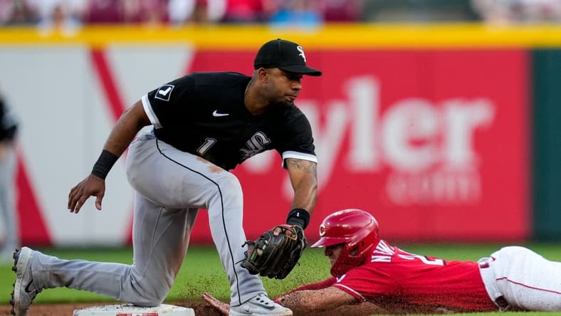 Cincinnati Reds shortstop Kevin Newman (28) dives in ahead of a tag from Chicago White Sox shortstop Elvis Andrus (1), stealing second, in the third inning of the MLB Interleague game between the Cincinnati Reds and the Chicago White Sox at Great American Ball Park in downtown Cincinnati on Friday, May 5, 2023.