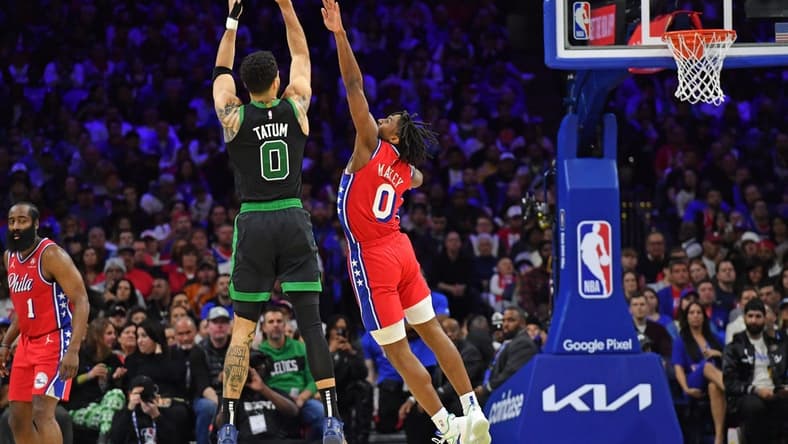 May 5, 2023; Philadelphia, Pennsylvania, USA; Boston Celtics forward Jayson Tatum (0) shoots a three point basket over Philadelphia 76ers guard Tyrese Maxey (0) during the second quarter of game three of the 2023 NBA playoff at Wells Fargo Center. Mandatory Credit: Eric Hartline-USA TODAY Sports