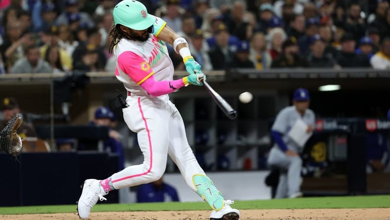May 5, 2023; San Diego, California, USA;  San Diego Padres right fielder Fernando Tatis Jr. (23) hits a home run during the fifth inning against the Los Angeles Dodgers at Petco Park. Mandatory Credit: Kiyoshi Mio-USA TODAY Sports