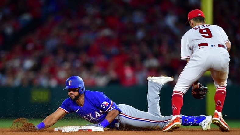 May 5, 2023; Anaheim, California, USA; Texas Rangers center fielder Leody Taveras (3) reaches second on a double ahead of Los Angeles Angels shortstop Zach Neto (9) during the fifth inning at Angel Stadium. Mandatory Credit: Gary A. Vasquez-USA TODAY Sports