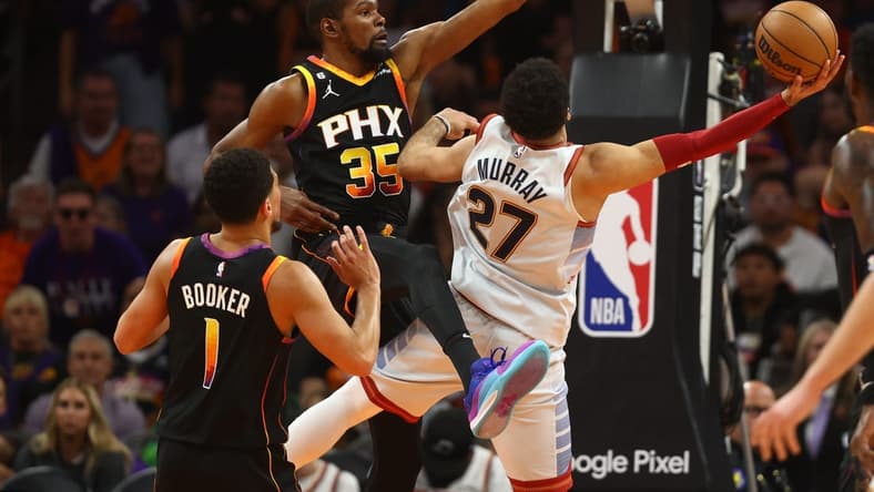 May 5, 2023; Phoenix, Arizona, USA; Phoenix Suns forward Kevin Durant (35) defends against Denver Nuggets guard Jamal Murray (27) in the first half during game three of the 2023 NBA playoffs at Footprint Center. Mandatory Credit: Mark J. Rebilas-USA TODAY Sports