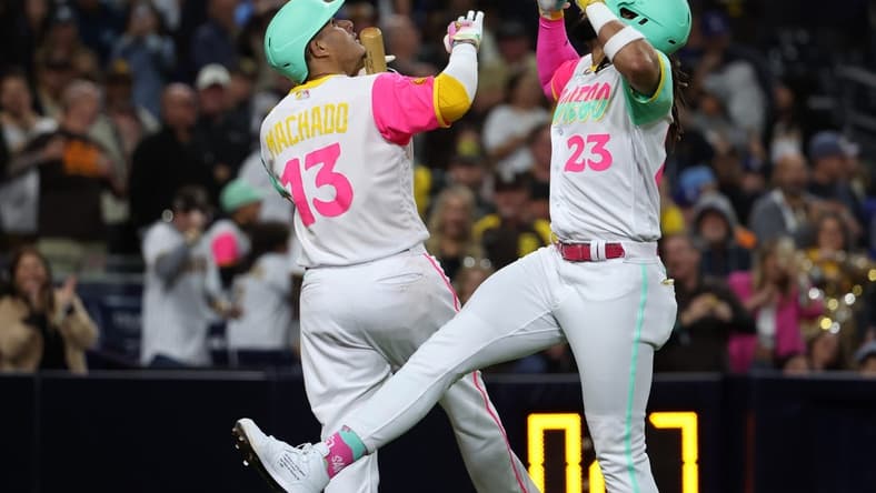 May 5, 2023; San Diego, California, USA;  San Diego Padres right fielder Fernando Tatis Jr. (23) celebrates with third baseman Manny Machado (13) after hitting a home run during the fifth inning against the Los Angeles Dodgers at Petco Park. Mandatory Credit: Kiyoshi Mio-USA TODAY Sports
