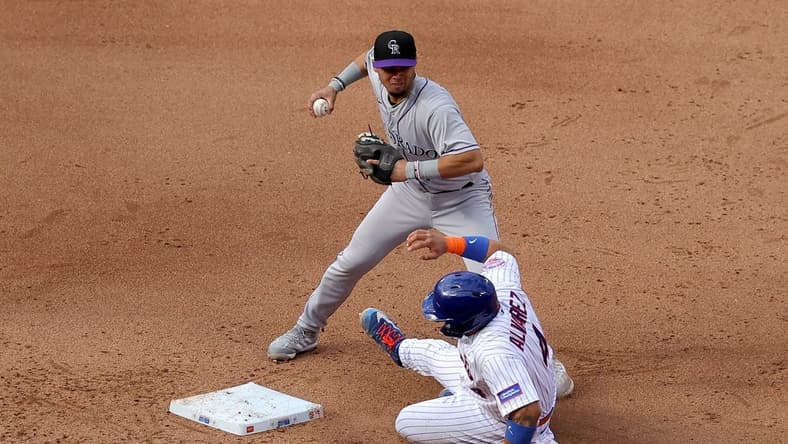May 6, 2023; New York City, New York, USA; Colorado Rockies shortstop Ezequiel Tovar (14) forces out New York Mets catcher Francisco Alvarez (4) at second base on a ground ball by Mets center fielder Brandon Nimmo (not pictured) during the fifth inning at Citi Field. Mandatory Credit: Brad Penner-USA TODAY Sports