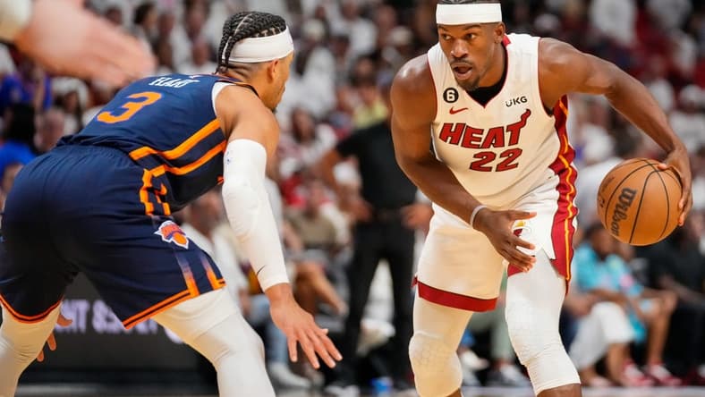 May 6, 2023; Miami, Florida, USA; Miami Heat forward Jimmy Butler (22) looks to dribble the ball as New York Knicks guard Miles McBride (2) defends during the second half of game three of the 2023 NBA playoffs at Kaseya Center. Mandatory Credit: Rich Storry-USA TODAY Sports