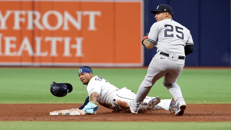 May 6, 2023; St. Petersburg, Florida, USA; Tampa Bay Rays shortstop Wander Franco (5) steals second base as New York Yankees second baseman Gleyber Torres (25) attempted to tag him out during the fifth inning at Tropicana Field. Mandatory Credit: Kim Klement-USA TODAY Sports