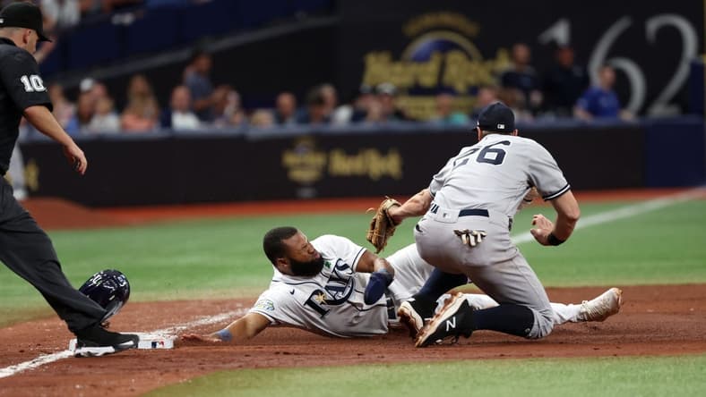May 6, 2023; St. Petersburg, Florida, USA; Tampa Bay Rays center fielder Manuel Margot (13) is tagged out by New York Yankees second baseman Gleyber Torres (25) during the sixth inning at Tropicana Field. Mandatory Credit: Kim Klement-USA TODAY Sports