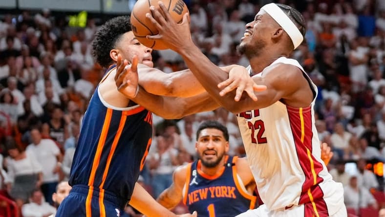 May 6, 2023; Miami, Florida, USA; New York Knicks guard Quentin Grimes (6) fouls Miami Heat forward Jimmy Butler (22) during the second half of game three of the 2023 NBA playoffs at Kaseya Center. Mandatory Credit: Rich Storry-USA TODAY Sports