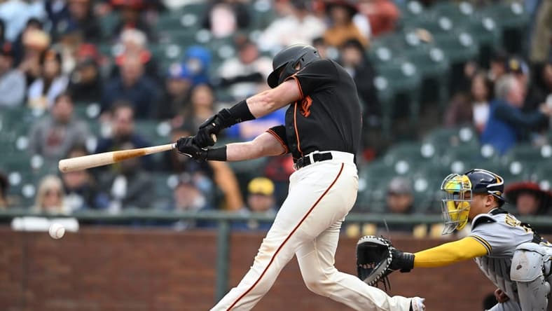 May 6, 2023; San Francisco, California, USA; San Francisco Giants catcher Joey Bart (21) hits an RBI double against the Milwaukee Brewers during the second inning at Oracle Park. Mandatory Credit: Robert Edwards-USA TODAY Sports