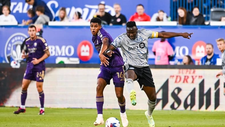 May 6, 2023; Montreal, Quebec, CAN; CF Montreal midfielder Victor Wanyama (2) defends the ball against Orlando City SC midfielder Wilder Cartagena (16) during the first half at Stade Saputo. Mandatory Credit: David Kirouac-USA TODAY Sports