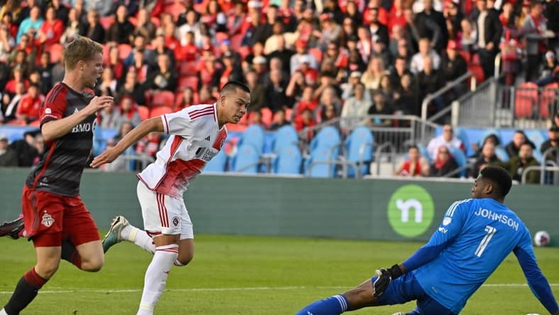 May 6, 2023; Toronto, Ontario, CAN;   New England Revolution forward Bobby Wood (17) scores a goal past Toronto FC goalkeeper Sean Johnson (1) in the first half at BMO Field. Mandatory Credit: Dan Hamilton-USA TODAY Sports