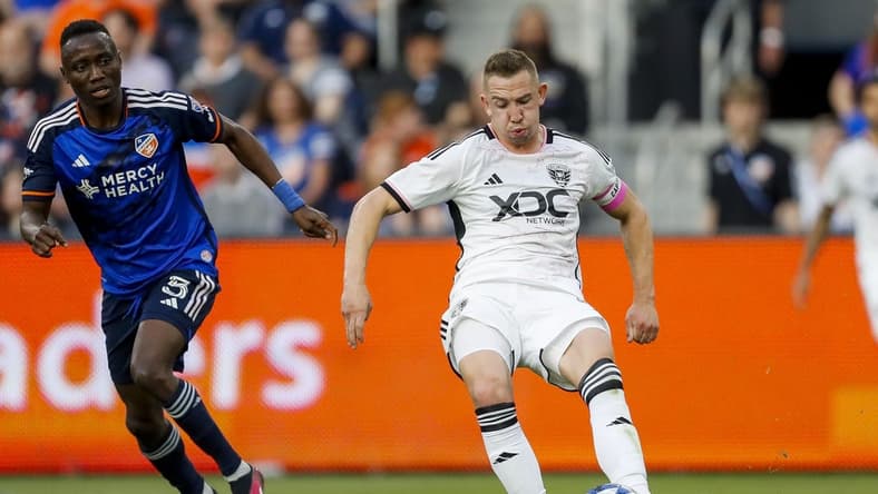 May 6, 2023; Cincinnati, Ohio, USA; D.C. United midfielder Russell Canouse (6) dribbles against FC Cincinnati midfielder Obinna Nwobodo (5) in the first half at TQL Stadium. Mandatory Credit: Katie Stratman-USA TODAY Sports