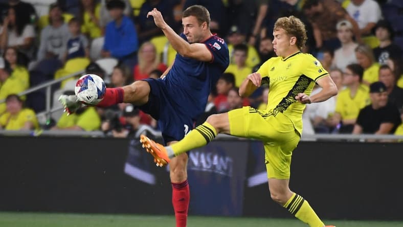 May 6, 2023; Nashville, Tennessee, USA; Chicago Fire defender Wyatt Omsberg (16) and Nashville SC forward Jacob Shaffelburg (14) in action during the first half at Geodis Park. Mandatory Credit: Christopher Hanewinckel-USA TODAY Sports