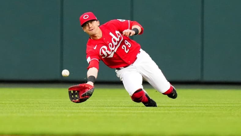 Cincinnati Reds center fielder TJ Friedl (29) completes a diving catch in the fifth inning during a baseball game between the Chicago White Sox and the Cincinnati Reds, Saturday, May 6, 2023, at Great American Ball Park in Cincinnati.