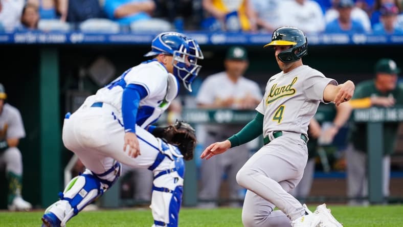 May 6, 2023; Kansas City, Missouri, USA; Oakland Athletics shortstop Kevin Smith (4) scores a run against Kansas City Royals catcher Freddy Fermin (34) during the fourth inning at Kauffman Stadium. Mandatory Credit: Jay Biggerstaff-USA TODAY Sports