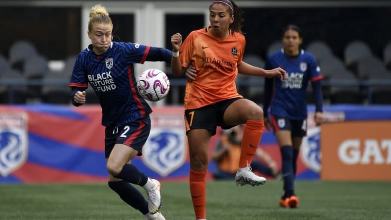 May 6, 2023; Seattle, Washington, USA; OL Reign defender Emily Sonnett (2) and Houston Dash forward Maria Sanchez (7) both go for the ball during the first half at Lumen Field. Mandatory Credit: Michael Thomas Shroyer-USA TODAY Sports