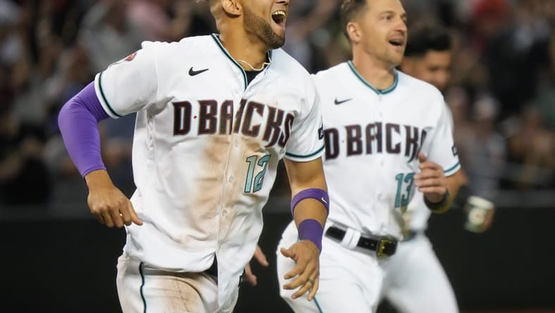 May 6, 2023; Phoenix, AZ, USA; Arizona Diamondbacks Lourdes Gurriel Jr. (12) and Nick Ahmed (13) run out on to the field to celebrate their 8-7 win over the Washington Nationals at Chase Field.