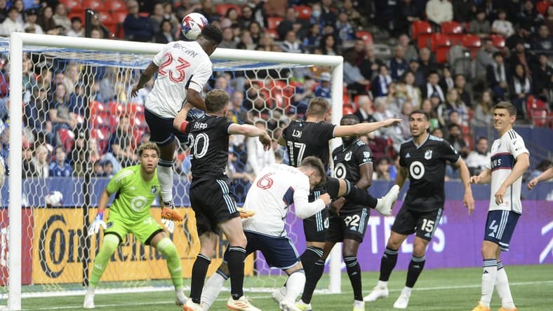 May 6, 2023; Vancouver, British Columbia, CAN;  Vancouver Whitecaps FC defender Javain Brown (23) heads the ball towards the net of Minnesota United FC goalkeeper Dayne St. Clair (97) during the first half at BC Place.  Mandatory Credit: Anne-Marie Sorvin-USA TODAY Sports
