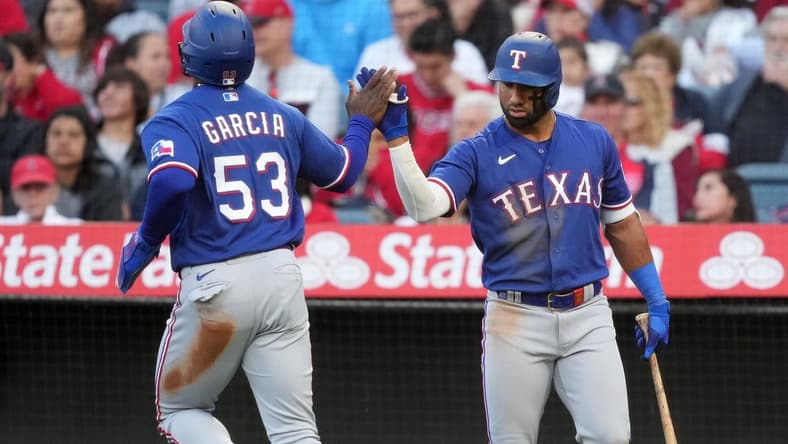 May 6, 2023; Anaheim, California, USA; Texas Rangers right fielder Adolis Garcia (53) celebrates with third baseman Josh Jung (6) after scoring in the fourth inning against the Los Angeles Angels at Angel Stadium. Mandatory Credit: Kirby Lee-USA TODAY Sports