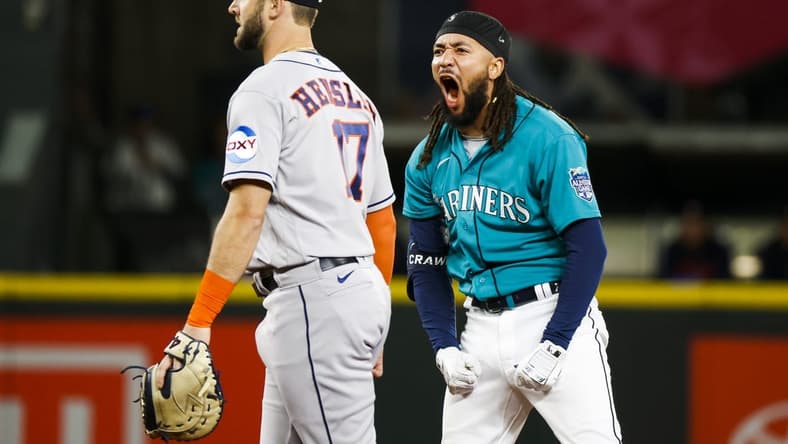 May 6, 2023; Seattle, Washington, USA; Seattle Mariners shortstop J.P. Crawford (3) reacts after hitting a three-run double against the Houston Astros during the eighth inning at T-Mobile Park. Houston Astros first baseman David Hensley (17) stands at left. Mandatory Credit: Joe Nicholson-USA TODAY Sports