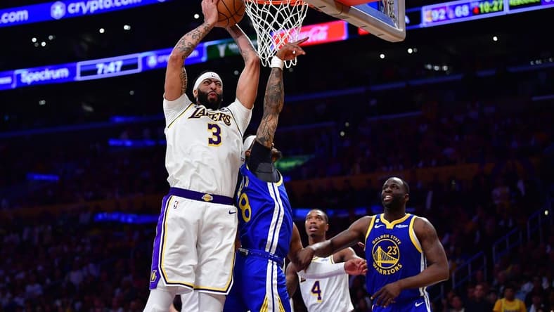 May 6, 2023; Los Angeles, California, USA; Los Angeles Lakers forward Anthony Davis (3) gets the rebound against Golden State Warriors guard Gary Payton II (8) and forward Draymond Green (23) during the second half in game three of the 2023 NBA playoffs at Crypto.com Arena. Mandatory Credit: Gary A. Vasquez-USA TODAY Sports
