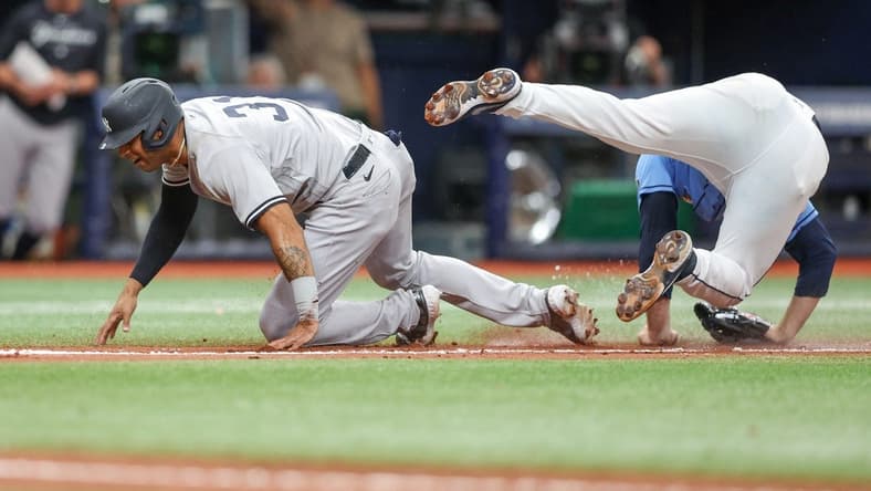 May 7, 2023; St. Petersburg, Florida, USA; New York Yankees left fielder Aaron Hicks (31) collides with Tampa Bay Rays relief pitcher Garrett Cleavinger (60) in the tenth inning at Tropicana Field. Mandatory Credit: Nathan Ray Seebeck-USA TODAY Sports