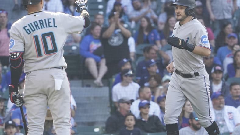 May 7, 2023; Chicago, Illinois, USA; Miami Marlins pinch-runner Garrett Hampson (1) scores on a balk and is greeted by first baseman Yuli Gurriel (10) against the Chicago Cubs during the fourteenth inning at Wrigley Field. Mandatory Credit: David Banks-USA TODAY Sports