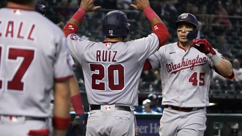 May 7, 2023; Phoenix, Arizona, USA; Washington Nationals designated hitter Joey Meneses (45) celebrates with catcher Keibert Ruiz (20) and left fielder Alex Call (17) hitting a three run home run against the Arizona Diamondbacks in the ninth inning at Chase Field. Mandatory Credit: Rick Scuteri-USA TODAY Sports