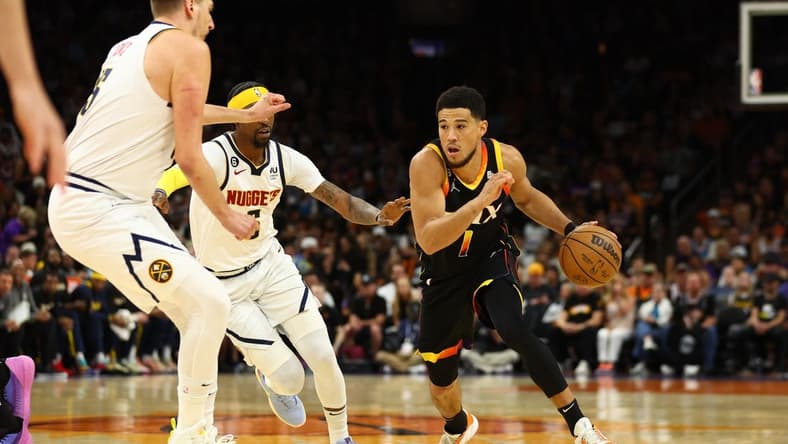 May 7, 2023; Phoenix, Arizona, USA; Phoenix Suns guard Devin Booker (1) against the Denver Nuggets in the first half during game four of the 2023 NBA playoffs at Footprint Center. Mandatory Credit: Mark J. Rebilas-USA TODAY Sports