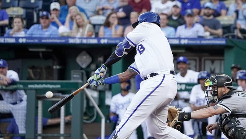 May 8, 2023; Kansas City, Missouri, USA; Kansas City Royals catcher Salvador Perez (13) hits a one run sacrifice fly against the Chicago White Sox in the first inning at Kauffman Stadium. Mandatory Credit: Denny Medley-USA TODAY Sports